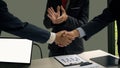 A business handshake in the office is an agreement to work together and people ignite the business