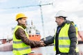 Business handshake in a shipyard. Shipbuilding industry