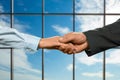 Business handshake on sky background. Royalty Free Stock Photo