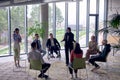 A business hijab woman in the center of a circle, passionately sharing his business ideas with his colleagues, fostering Royalty Free Stock Photo