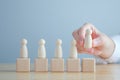 Hand Choose figure standing out from the group of crowd. Business hiring and recruitment selection concept.