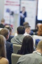 Business Ideas and Concepts. People at the Business Conference Listening to Host in Front of the Stage