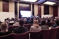 Business Ideas. Distant Male Host Speaking In Front of the Group of Business People During a Conference