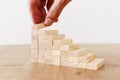 Business image of arranging wood blocks stacking as step stairs. Success and development concept