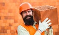 Business, industry, technology. Builder concept. Young construction workers in hard hats on orange background with smile Royalty Free Stock Photo