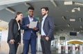 Business inspectors using tablet and talking about business together in front of skytrain fare gates Royalty Free Stock Photo