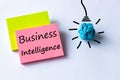 Business intelligence, written on a piece of paper, light bulb icon, concept for business plan, data mining, market analysis and Royalty Free Stock Photo