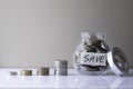 Coins in glass bottle with money stack step up growing growth Royalty Free Stock Photo