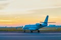 Business jet on the apron of aircraft. Dawn at