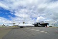 Business jet next to a hangar at the airport Royalty Free Stock Photo