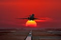 Business jet take off from airport runway against the backdrop crimson sunset Royalty Free Stock Photo