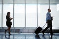Business jetsetters. businesspeople walking down a corridor in an airport while on a business trip. Royalty Free Stock Photo