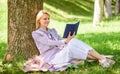 Business lady find minute to read book improve her knowledge. Female self improvement. Girl lean on tree while relax in