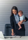 Business lady with her baby Royalty Free Stock Photo