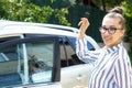 Business lady tears off the car holding a phone in his hand. Young attractive girl in a business style in a shirt and black pants Royalty Free Stock Photo
