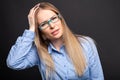 Business lady wearing blue glasses holding head like hurting Royalty Free Stock Photo