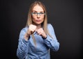 Business lady wearing blue glasses posing showing fists like fig Royalty Free Stock Photo