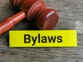 Phrase BYLAWS written on sticky note with gavel. Royalty Free Stock Photo