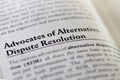 Focus on common business term advocates of Alternative dispute resolution ADR printed on page in legal textbook Royalty Free Stock Photo