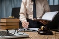 Business lawyer working hard at office desk workplace with book