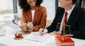 Business and lawyers discussing contract papers with brass scale on desk in office. Law, legal services, advice, justice and law Royalty Free Stock Photo