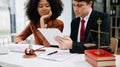 Business and lawyers discussing contract papers with brass scale on desk in office. Law, legal services, advice, justice and law Royalty Free Stock Photo