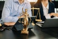 Business and lawyers discussing contract papers with brass scale on desk in office. Law, legal services, advice, justice and law Royalty Free Stock Photo