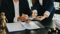 Business and lawyers discussing contract papers with brass scale on desk in office. Law, legal services, advice, justice and law Royalty Free Stock Photo