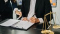 Business and lawyers discussing contract papers with brass scale on desk in office. Law, legal services, advice, justice and law Royalty Free Stock Photo