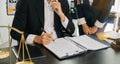 Business and lawyers discussing contract papers with brass scale on desk in office. Law, legal services, advice, justice and law Royalty Free Stock Photo