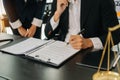 Business and lawyers discussing contract papers with brass scale on desk in office. Law, legal services, advice, justice and law Royalty Free Stock Photo