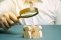 Business leader holding a magnifying glass over a team of workers. The concept of finding new employees. Teamliding. Team