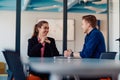 A business leader in a suit conversing with her worker in the IT industry about new business projects and existing