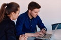 A business leader in a suit conversing with her worker in the IT industry about new business projects and existing