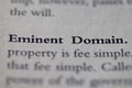 Business legal term Eminent Domain printed in textbook on white page.