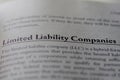 Business legal term Limited Liability Company LLC printed in textbook on white page.