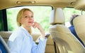 Business life concept. Business woman sit on backseat. Busy lady passenger leather car salon enjoy journey with