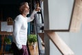 Business lifestyle. Casual Grey-haired Mature professional handsome businessman standing near window in his office