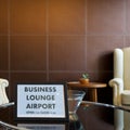 The Business Lounge Airport service time sign is placed on a modern round tempered glass table Royalty Free Stock Photo