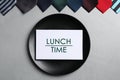 Business lunch. Card with phrase Lunch Time, plate and different ties on light gray table, flat lay