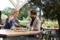 Business lunch for two managers, discussing new business project. Couple sitting outdoors on terrace restaurant, having Royalty Free Stock Photo