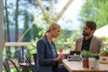 Business lunch for two managers, discussing new business project. Couple sitting outdoors on terrace restaurant, having Royalty Free Stock Photo