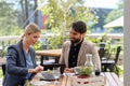 Business lunch for two managers, discussing new business project. Couple sitting outdoors on terrace restaurant, having Royalty Free Stock Photo