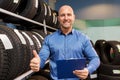 Auto business owner and wheel tires at car service Royalty Free Stock Photo