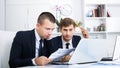 Business male assistants making mistake Royalty Free Stock Photo