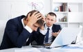 Business male assistants making mistake Royalty Free Stock Photo