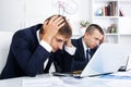 Business male assistants making mistake Royalty Free Stock Photo