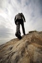 Business Male person is walking up to top of a mountain a high steep hill for success cocnept Royalty Free Stock Photo