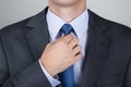 Business man adjusting his neck tie Royalty Free Stock Photo
