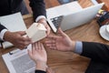 man applying for mortgage loan with bank employee. client signing contract document with realtor at real estate agency.